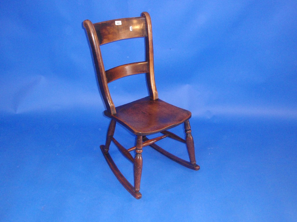 Appraisal: A Victorian lath back rocking chair