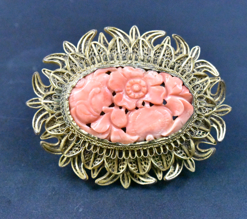 Appraisal: A gilt brooch inlaid with a carved coral flower Oval