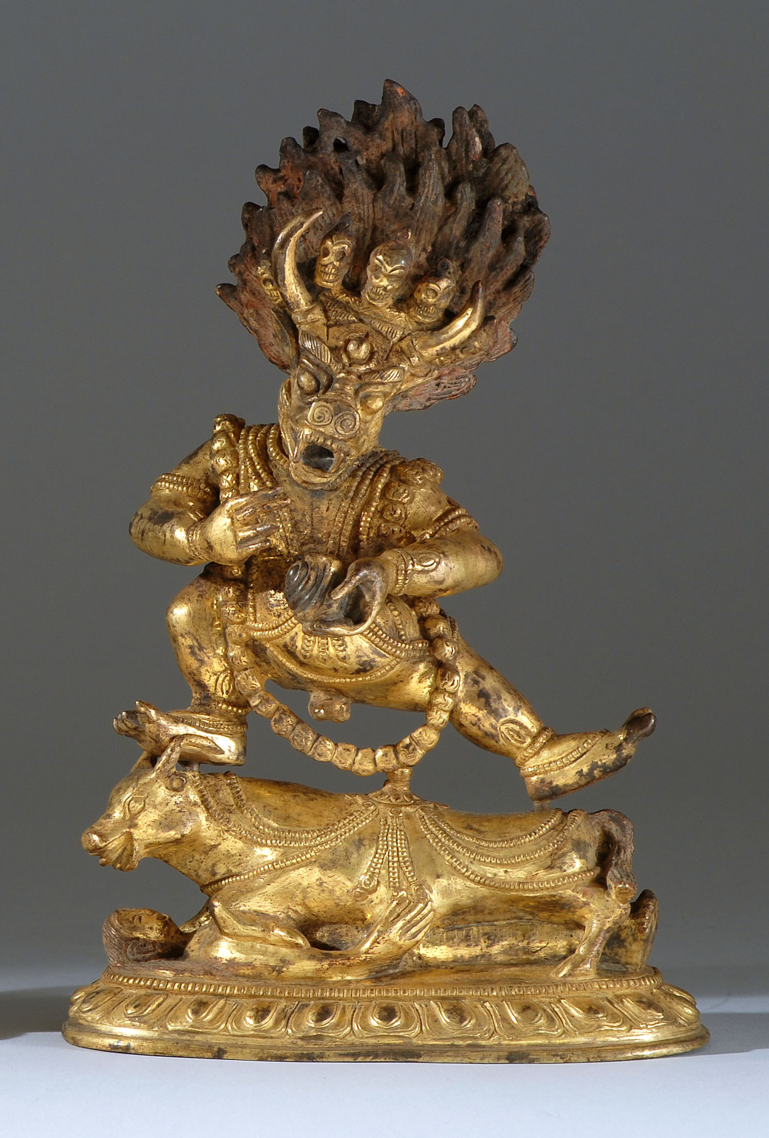 Appraisal: GILT-BRONZE FIGURE OF YAMANTAKA Wearing a skull apron and dancing