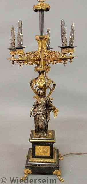 Appraisal: Large bronze and gilt table candelabra with a robed maiden