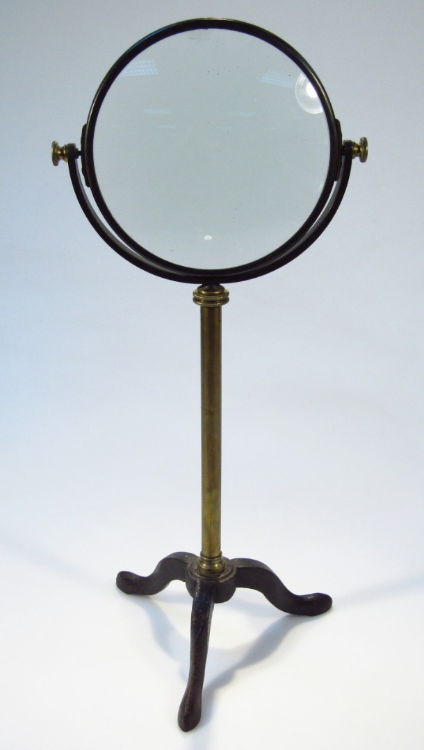 Appraisal: A thC table magnifying glass the circular articulated top on