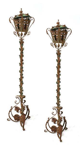 Appraisal: A pair of wrought iron floral decorated floor lanterns height