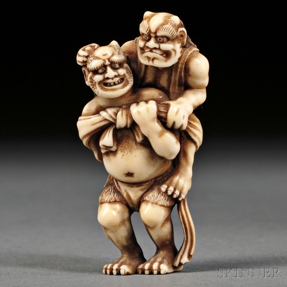 Appraisal: Ivory Netsuke of Two Oni Japan th century one carrying