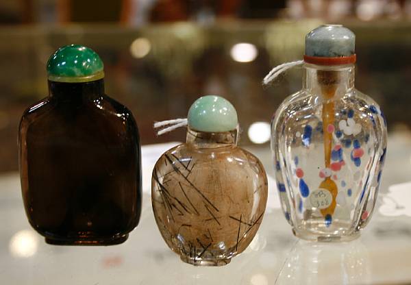 Appraisal: Three snuff bottles The first of clear glass spotted with