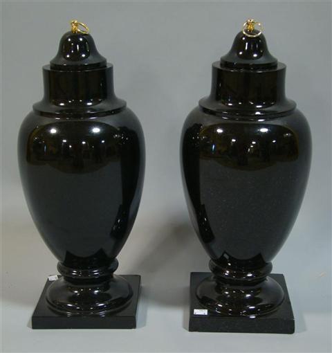 Appraisal: PAIR OF BLACK STONE URNS Of tapered ovoid form rising