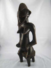 Appraisal: An Ivory Coast Senufo tribal figure of a woman seated