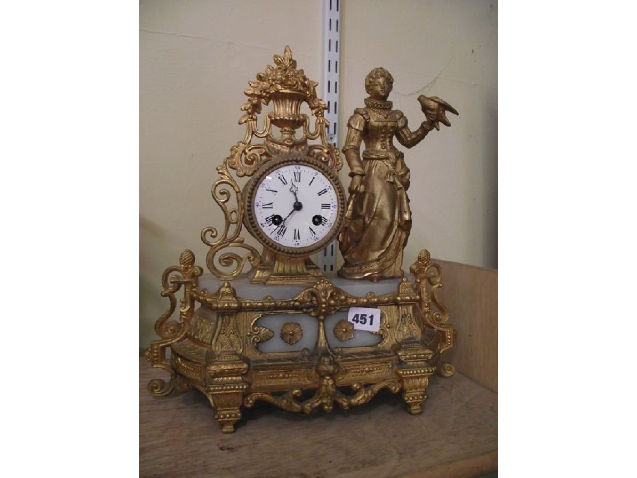 Appraisal: A th century gilded spelter mantel clock with additional onyx