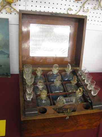 Appraisal: th Century Travel Bar or Tantalus bottle mahogany case bottles