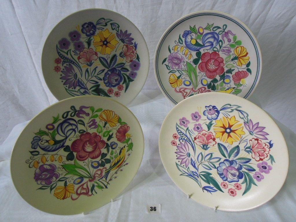 Appraisal: Four Poole Pottery plates decorated with flowers in various designs