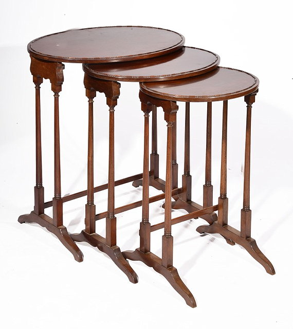 Appraisal: A NEST OF THREE MAHOGANY OVAL OCCASIONAL TABLES each with