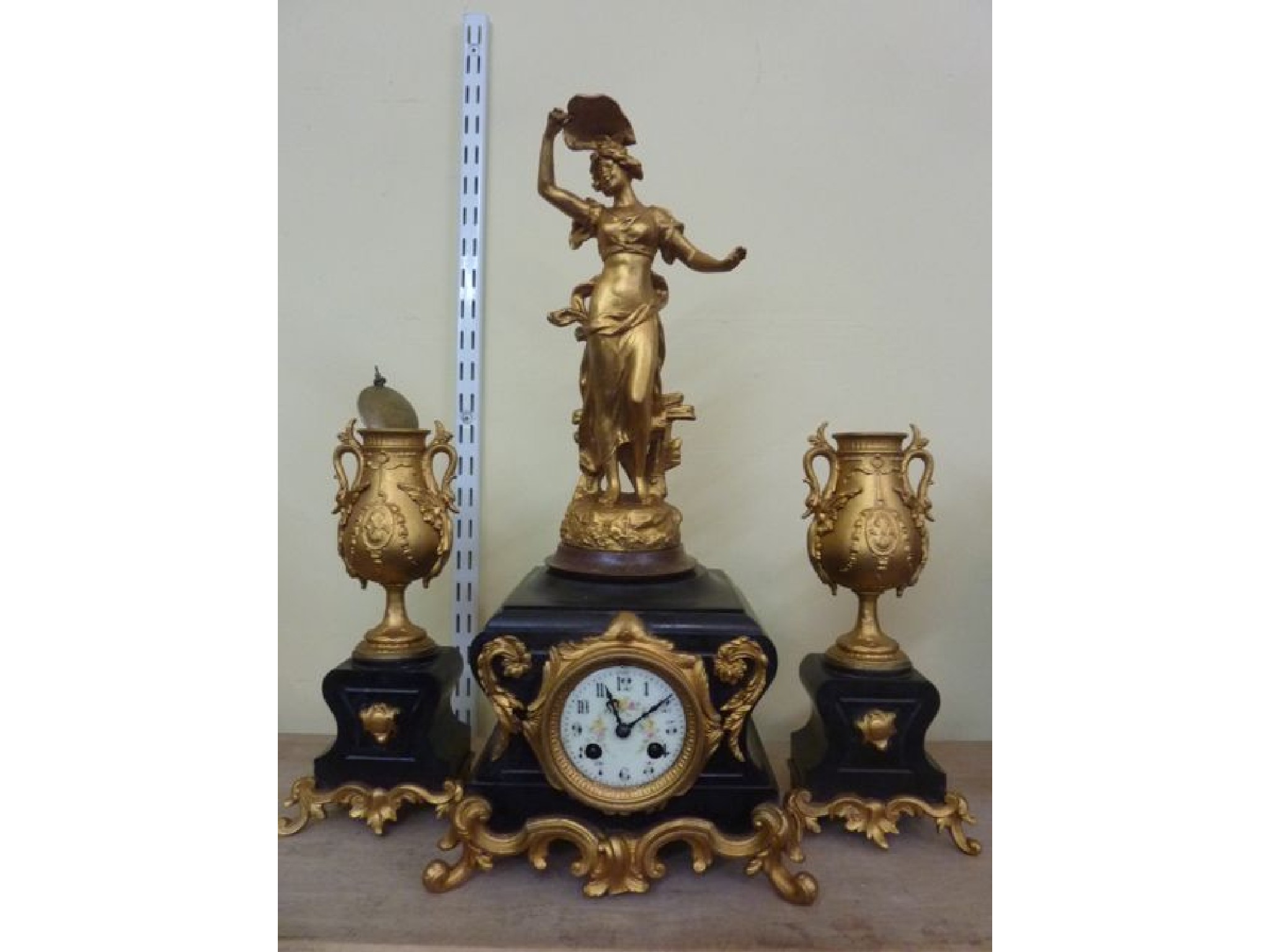 Appraisal: A Victorian black slate clock garniture with applied and scrolling