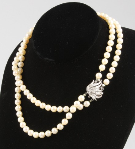 Appraisal: KW mm to mm cultured pearls cream color diamond clasp