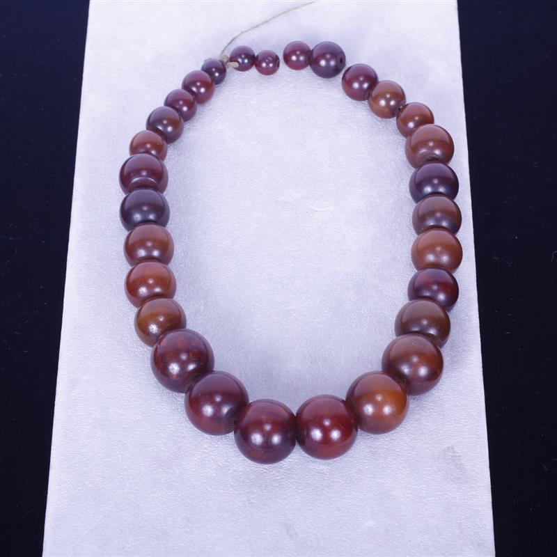 Appraisal: Graduated Amber color beads unknown material Largest Bead Dia