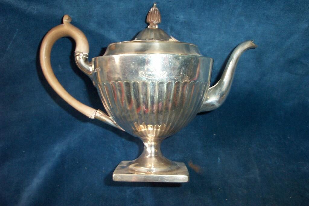 Appraisal: A classical style silver teapot with urn shaped body shaped