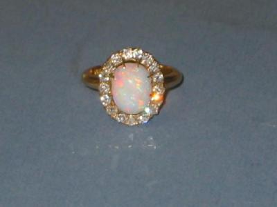 Appraisal: A VICTORIAN OPAL RING the oval stone surrounded by seventeen