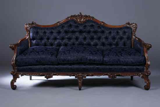 Appraisal: MID VICTORIAN CARVED MAHOGANY SOFA th century blue damask upholstery