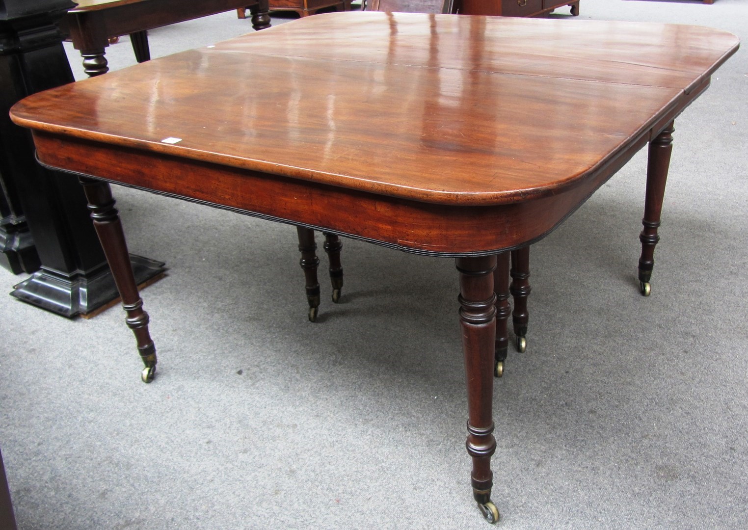 Appraisal: A Regency mahogany extending dining table on tapering turned supports