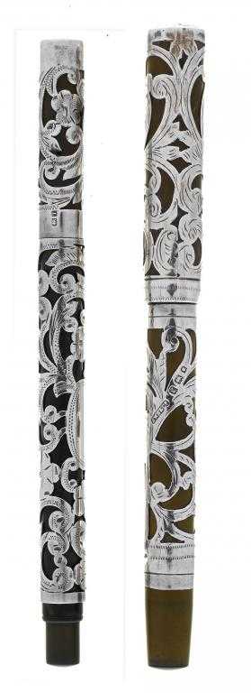 Appraisal: TWO ENGRAVED SILVER-OVERLAID FOUNTAIN PENS eyedropper and lever fill the