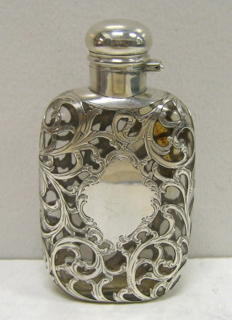 Appraisal: STERLING SILVER OVERLAY GLASS FLASK Flatten glass bottle with foliate