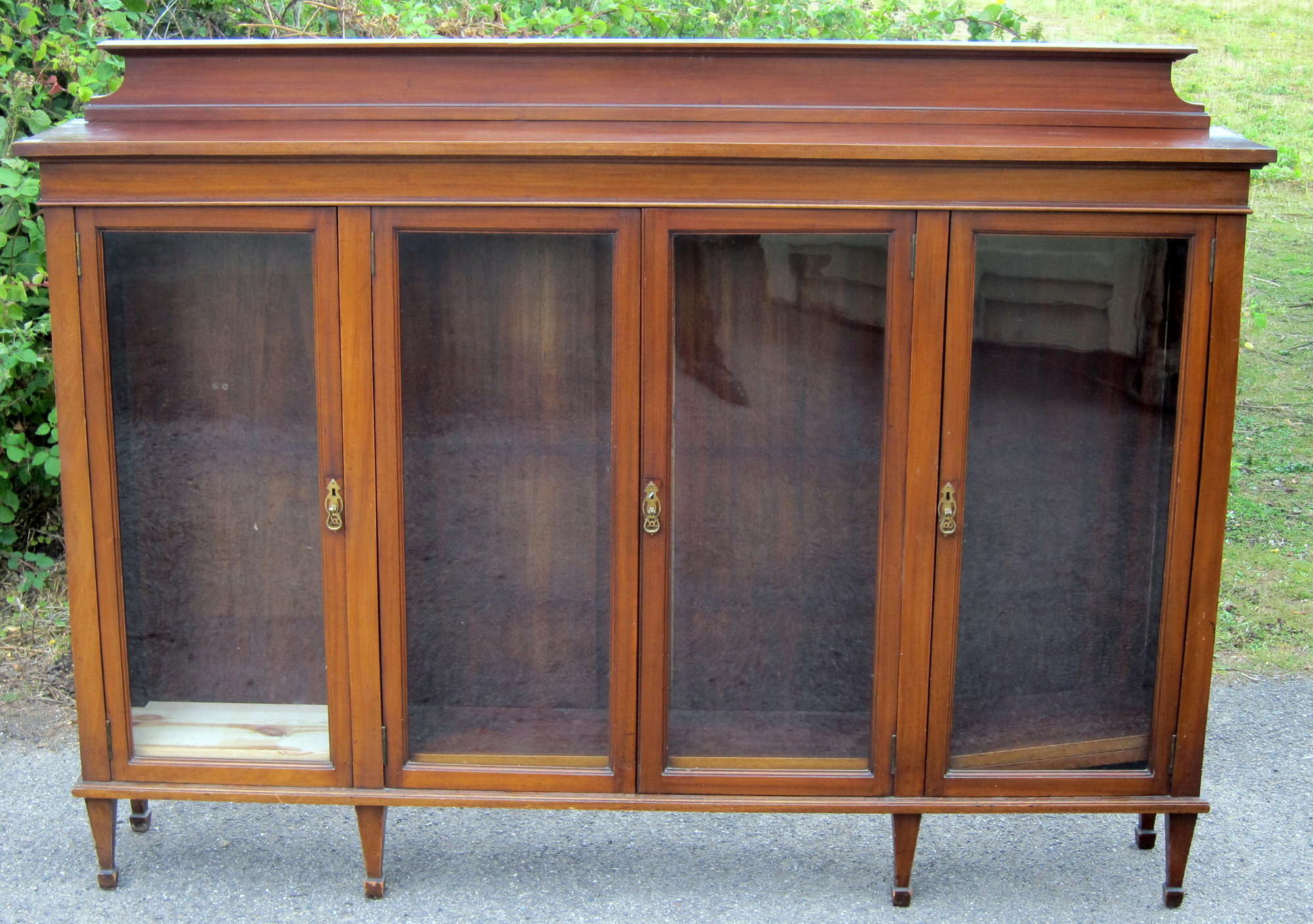 Appraisal: An early th C Mahogany and glazed four door bookcase