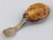 Appraisal: A silver mounted cowrie shell caddy spoon by Matthew Linwood