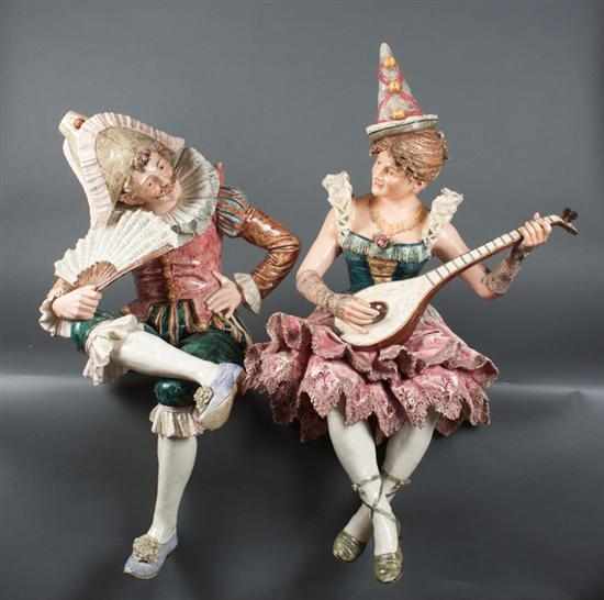 Appraisal: Pair of German majolica seated figures of th century traveling