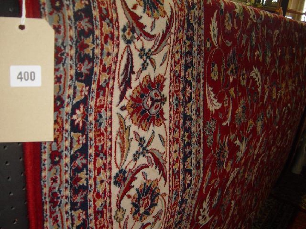 Appraisal: A red ground wool carpet in the Persian style with