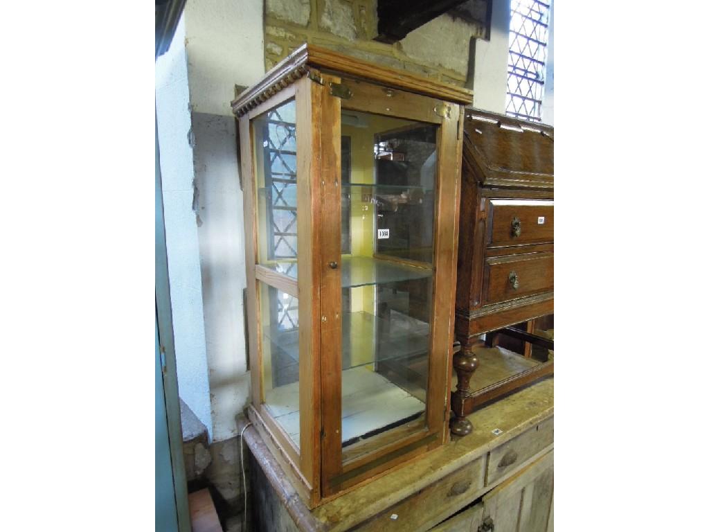 Appraisal: A stripped pine framed display case of square cut form