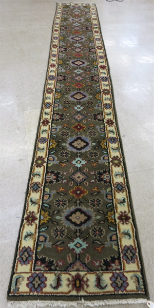 Appraisal: HAND KNOTTED ORIENTAL RUNNER Indo-Persian overall floral decoration on olive