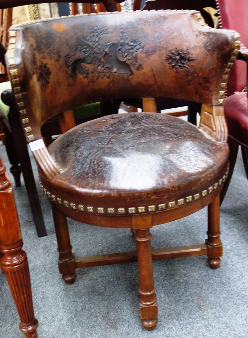 Appraisal: A th century French mahogany framed brass studded embossed leather