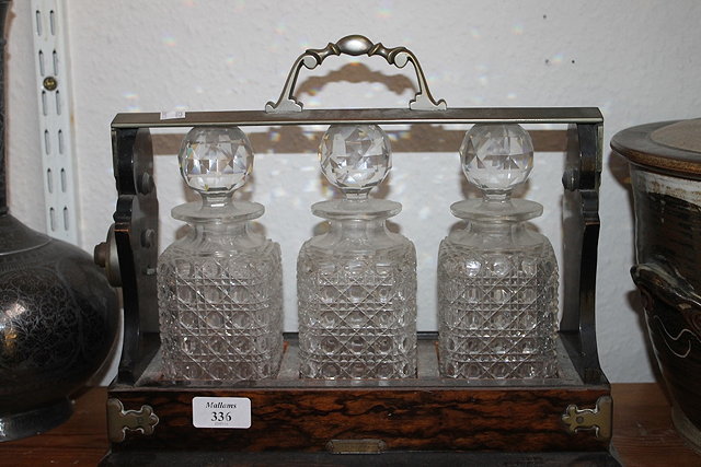 Appraisal: A VICTORIAN COROMANDEL TANTALUS fitted three glass bottles with label