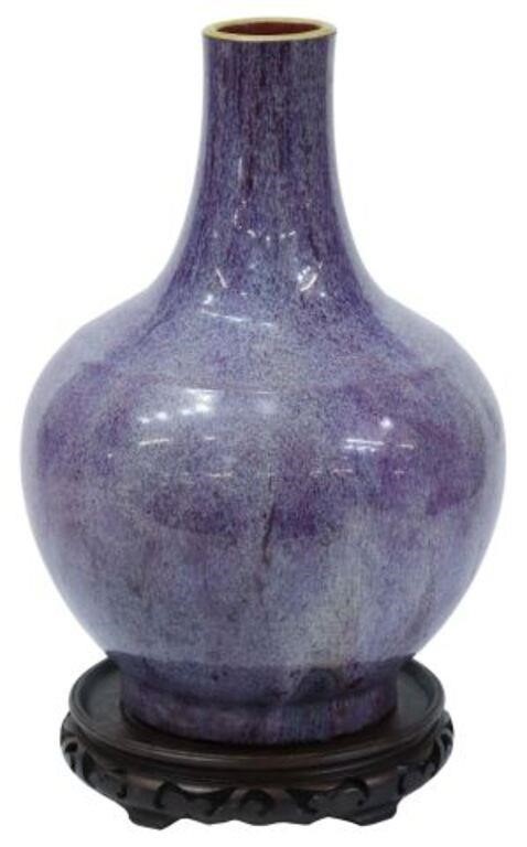 Appraisal: Chinese flambe porcelain vase bottleneck form rising on carved wood