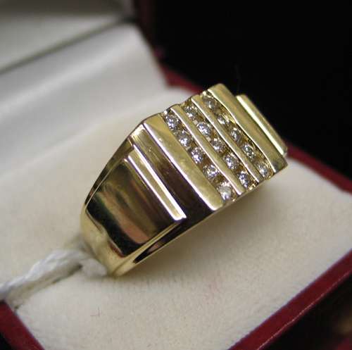 Appraisal: MAN'S DIAMOND AND FOURTEEN KARAT GOLD RING with three channels