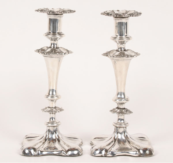 Appraisal: A pair of silverplate Sheffield candlesticks with flared base and