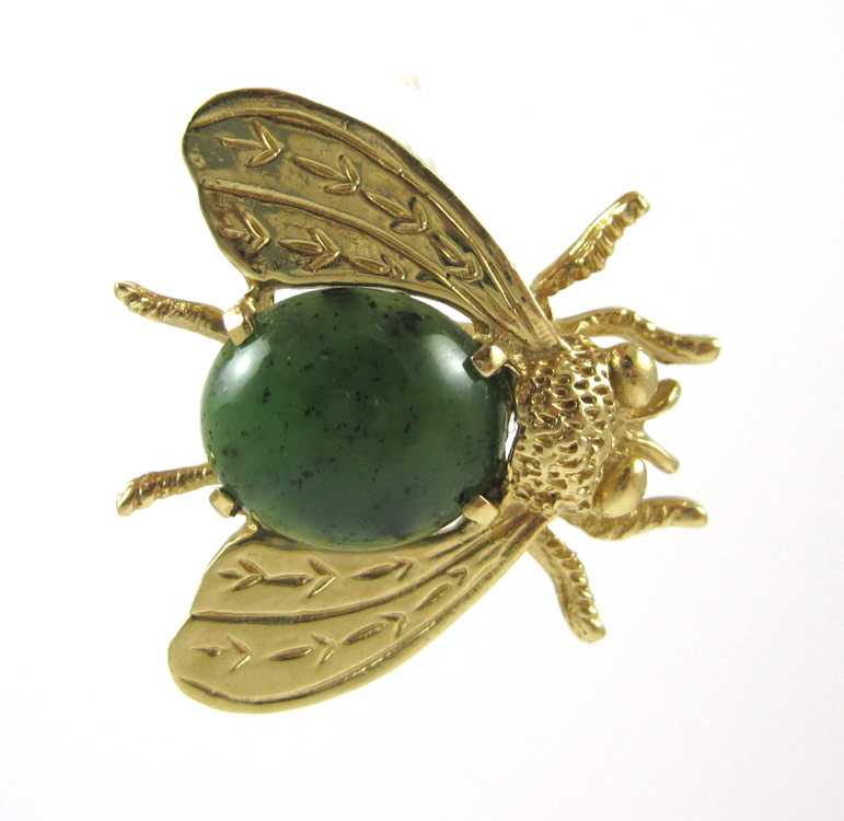 Appraisal: GREEN HARDSTONE AND FOURTEEN KARAT GOLD BROOCH The yellow gold