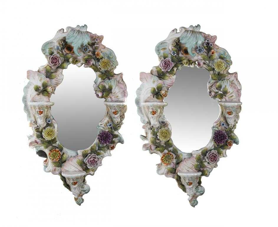 Appraisal: A PAIR OF SITZENDORF FLORAL ENCRUSTED MIRRORS in rococo style