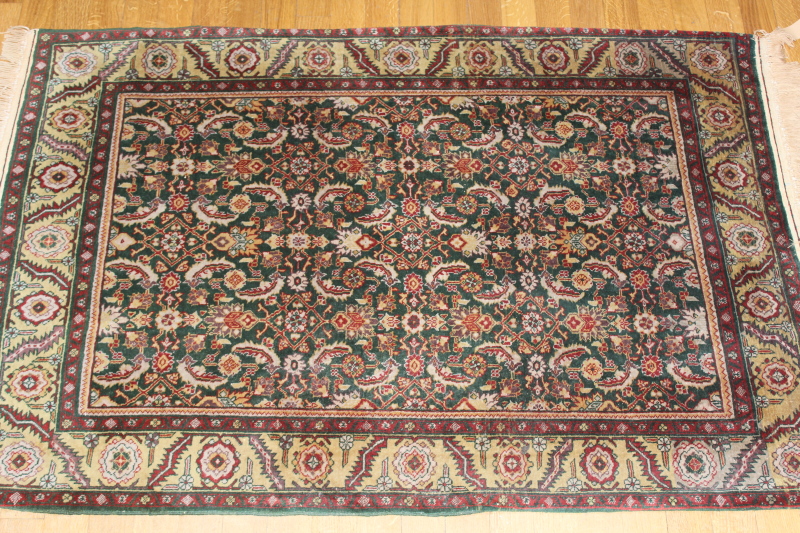 Appraisal: A small Eastern bordered rug on a green ground cm