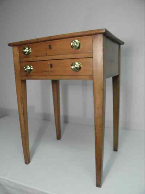 Appraisal: A small maple two-drawer side table with four square tapering