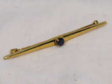 Appraisal: A carat gold bar brooch set with a sapphire