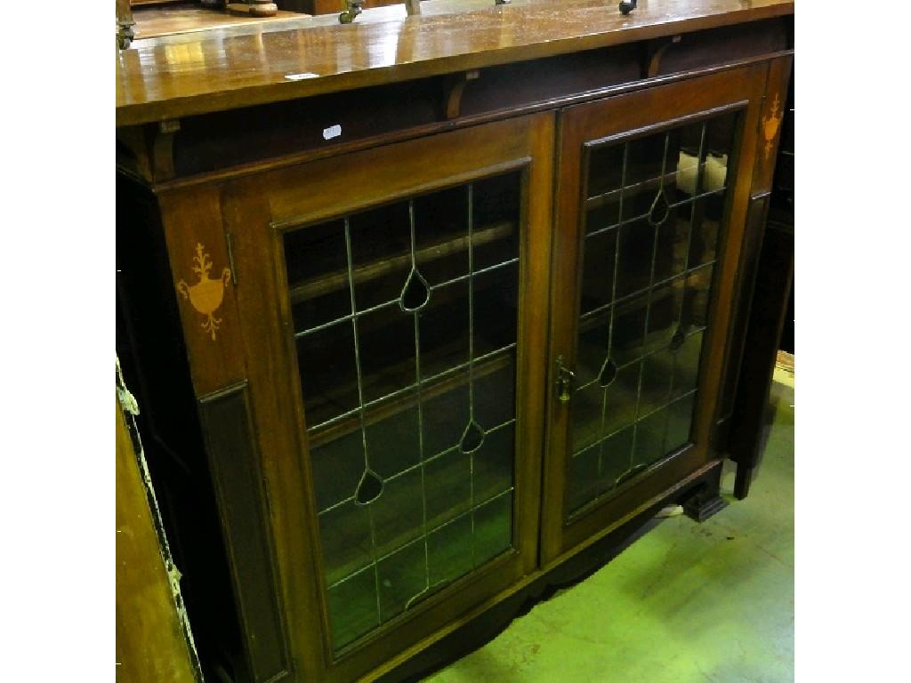 Appraisal: An Edwardian Art Nouveau style mahogany display cabinet the overhanging