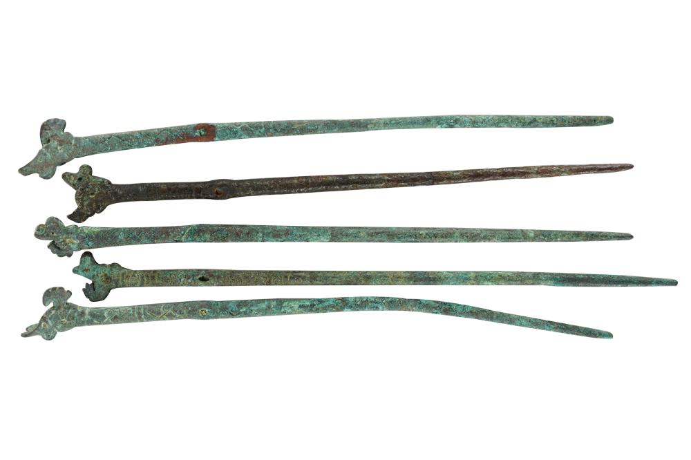 Appraisal: FIVE PERSIAN HELMET PINSbronze stick pins with dog motif Condition