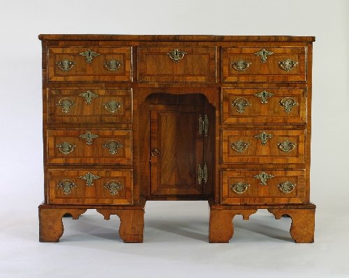 Appraisal: A George II walnut kneehole desk with cross and feather