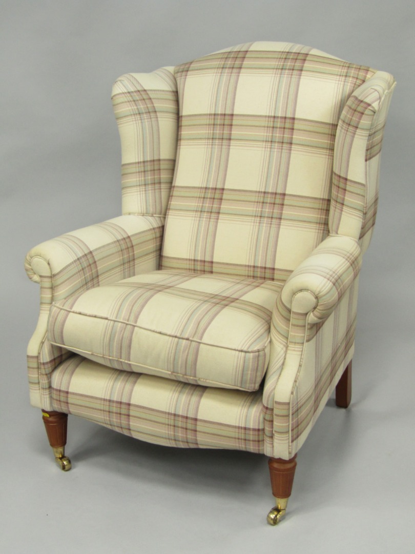 Appraisal: A Laura Ashley oak framed wing armchair upholstered in cream