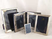 Appraisal: Silver photo frames A small oak strut backed frame x