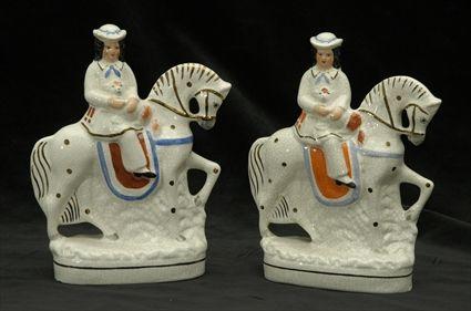 Appraisal: Pair of Staffordshire Pottery Figures of Girls on Horseback Each