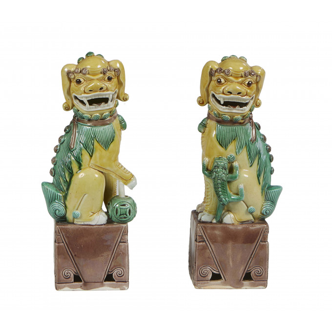 Appraisal: Pair of Chinese Polychromed Earthenware Foo Dogs th c on