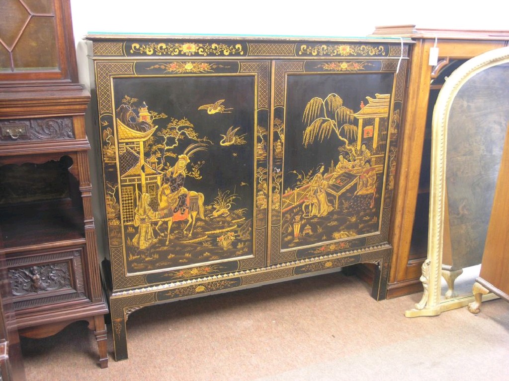 Appraisal: An early th century chinoiserie-lacquered bookcase pair of panelled cupboard