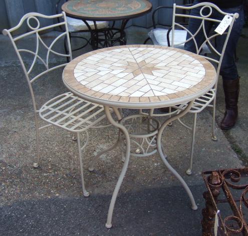 Appraisal: A cream painted mosaic top garden table and two matching