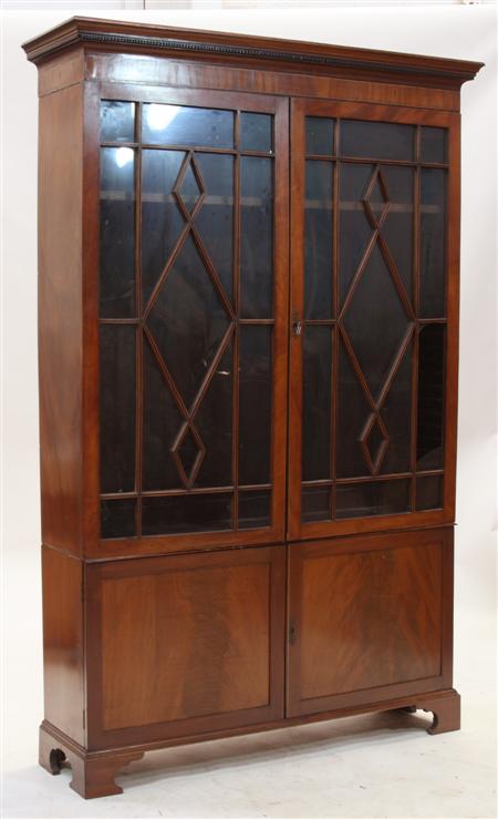 Appraisal: A th century mahogany bookcase the projected dentil cornice above