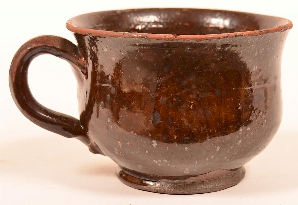 Appraisal: Manganese Glazed Redware Pottery Mug th Century Manganese Glazed Redware